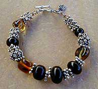 Jet, Amber, and Sterling Silver necklace, bracelet and earrings by Vicky Jousan